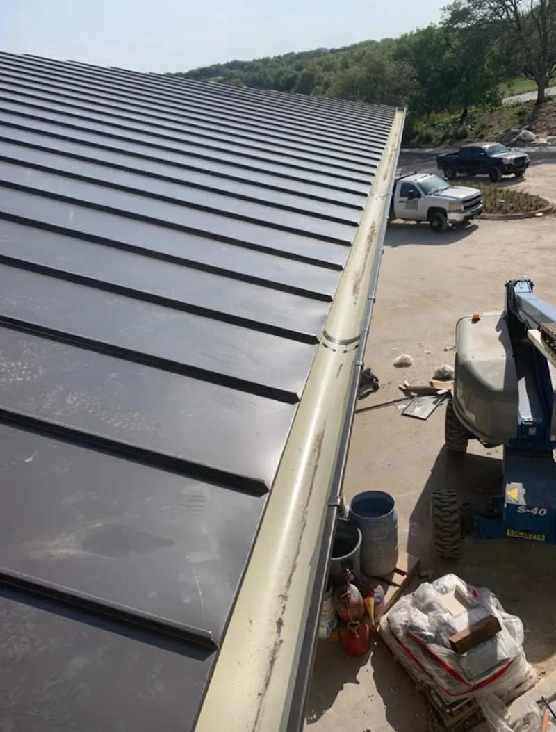 Standing seam panel and gutter detail on a metal roofing jobsite in Triana